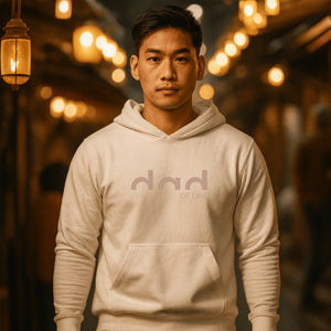 Beige hoodie with a “dad” design on the front.